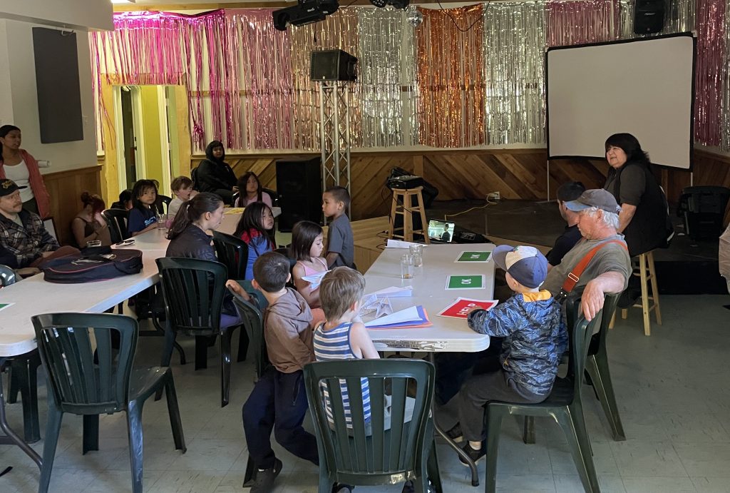 School children sitting at tables learning about preparedness from a leader.